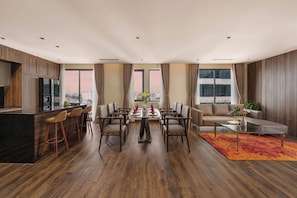 A modern hotel room with a dining area, kitchen, and seating space. - Palazzo 3 (Da Nang Municipality)