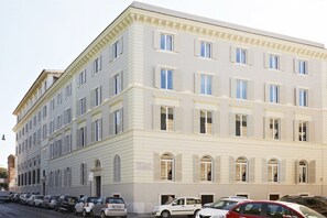 A multi-story building with a symmetrical facade, large windows, and a flat roof. - The Building (Rome)