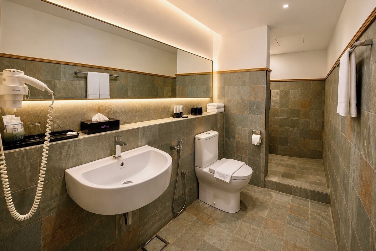 Une salle de bain moderne avec un lavabo, des toilettes et une douche.