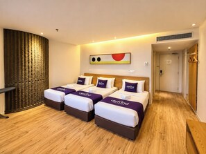 A hotel room with three beds, a wooden floor, a large window with a view, and a modern design. - de King Hotel Klcc (Kuala Lumpur)
