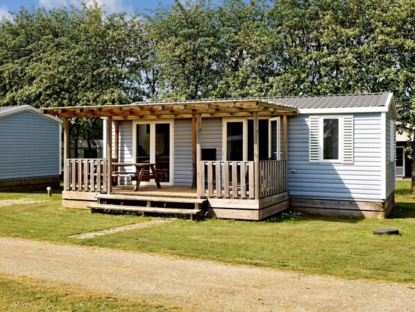 Enjoy a peaceful retreat in this cozy home with a deck and covered porch.
