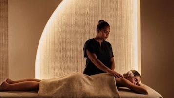 Experience a serene massage in a unique, curved room with a soothing ambiance.