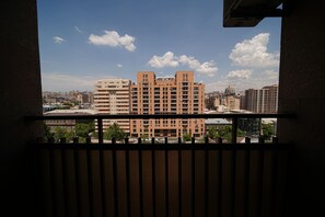 A high-rise building with multiple balconies, a clear sky, and distant cityscape. - City View 2-bedroom Luxury Apartment on 13 Buzand Street by Sweet Home (Yerevan)