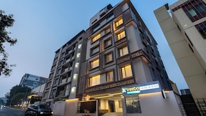 A multi-story hotel with a modern facade, a visible entrance, and a sign indicating the name and location. - Treebo Premium Lalitha, RK Beach (Visakhapatnam)