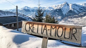 A wooden sign with the text "CRETTA-MOUR" in front of a snowy mountain landscape. - Crettamour by Interhome (Veysonnaz)