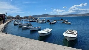 A marina with several small boats docked along a waterfront. - Apartments Smokvica - One Bed/Apt with Balcony (Starigrad-Paklenica)