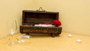 A wooden chest with a hinged lid, a red rose, and two candles on a table. - Villa Iveta - Twin Room (Ground Floor) - Martina (Dubrovnik)