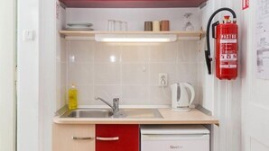 A compact kitchen with a sink, a kettle, and a dishwasher. - Villa Iveta - Twin Room (Ground Floor) - Martina (Dubrovnik)