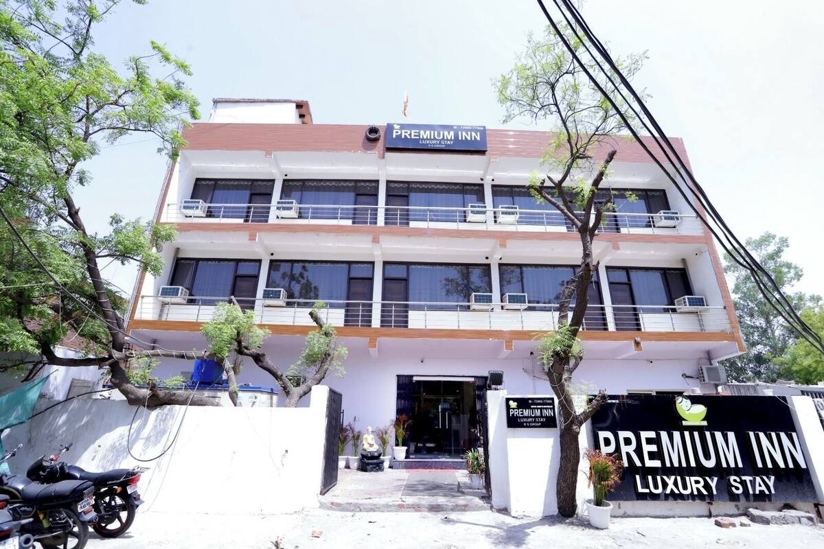 A multi-story building with a sign reading "Premium Inn Luxury Stay".