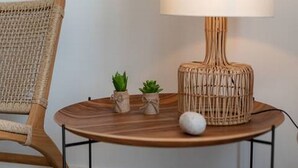 A round wooden table with a woven lamp, two small potted plants, and a white spherical object. - Mamma mia luxury rooms - Double Room with Sea View (Relaxing beachfront paradise) - 2 (Trogir)