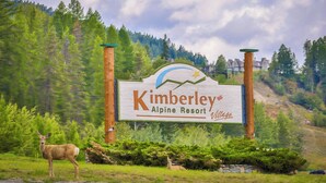 Schild für das Kimberley Alpine Resort, im Vordergrund ein Reh.