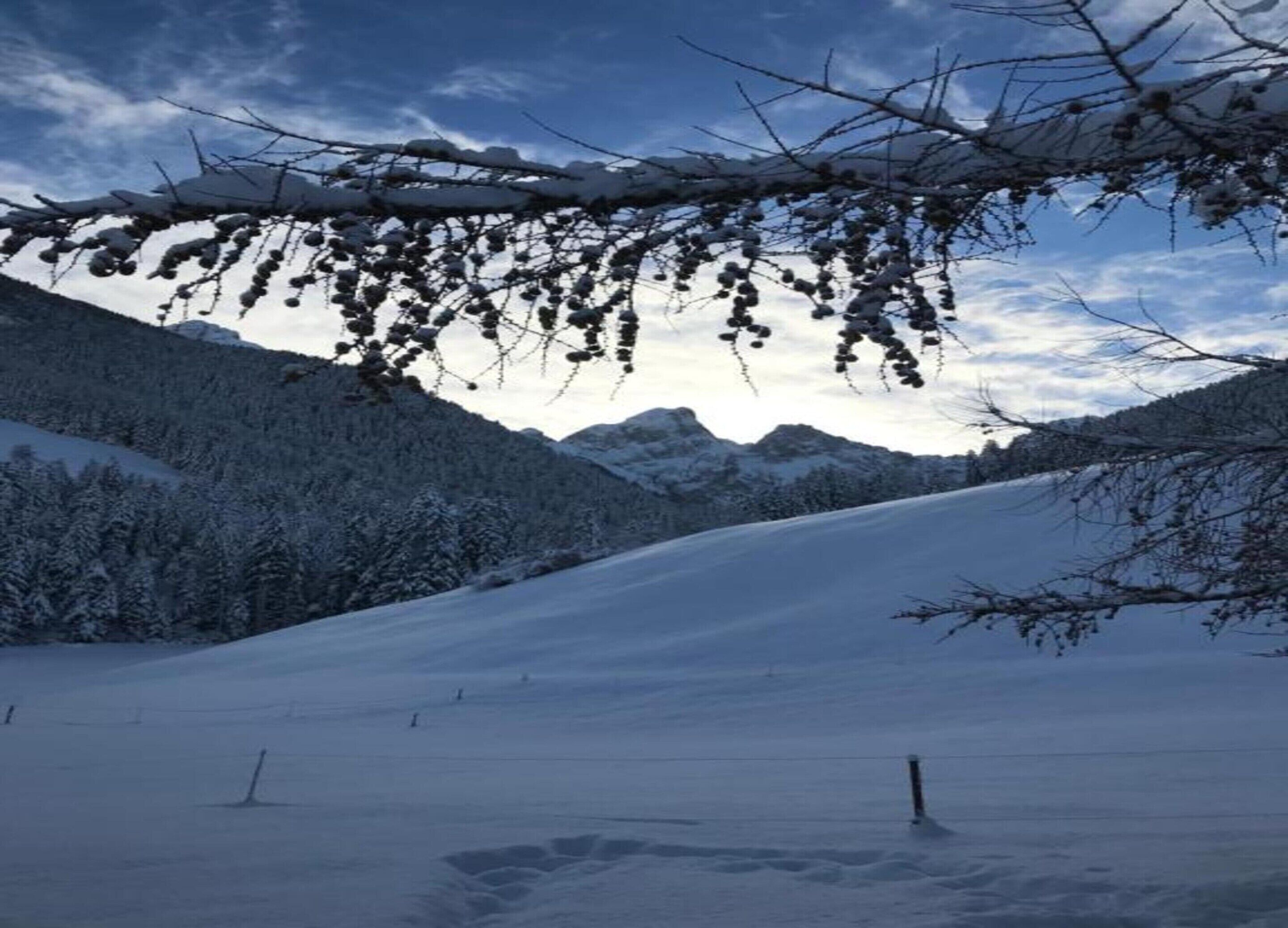 A snowy mountain landscape with a clear sky.
