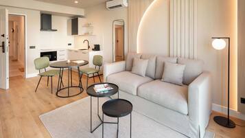 Deluxe Apartment, 1 Bedroom, City View | Living area | 55-inch Smart TV with digital channels