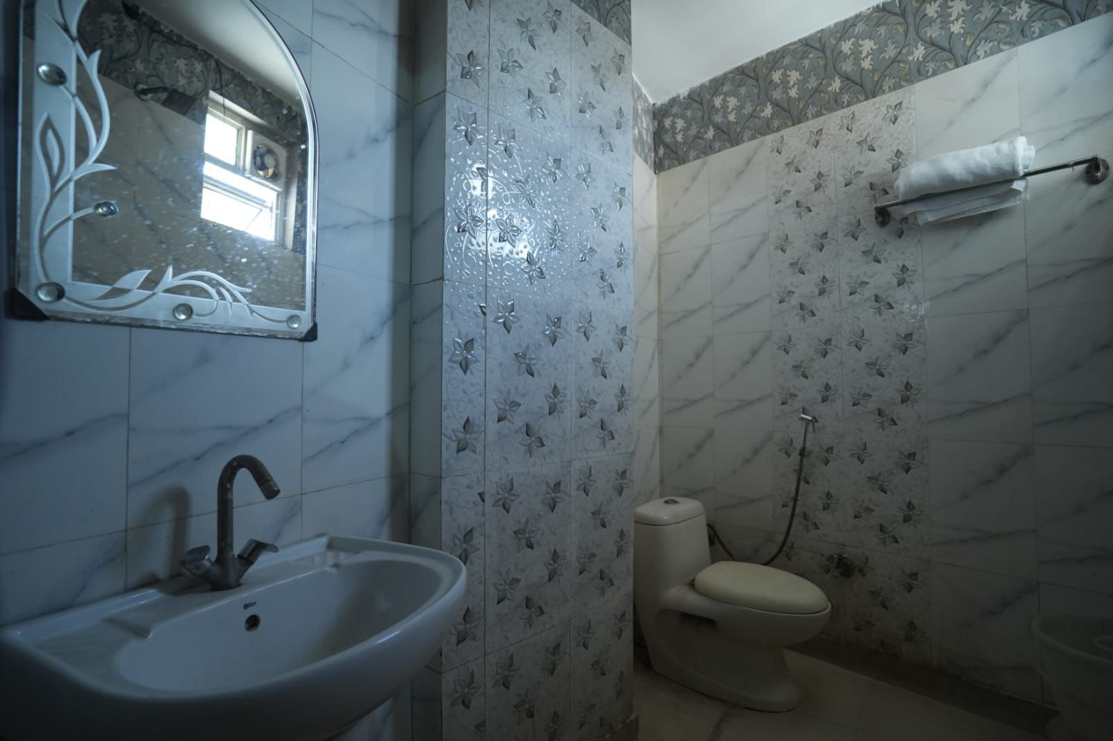 A bathroom with a sink, toilet, and shower.