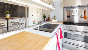 A modern kitchen with a stainless steel stove, a double sink, and a wooden countertop. - Charm and style in downtown Catania (Catania)