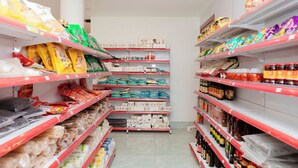 A grocery store aisle with shelves stocked with various packaged goods, including snacks, condiments, and household items. - Noi Bai Airport Hotel  (Hanoi)