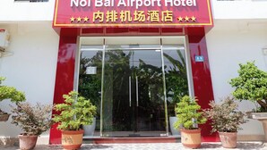 A hotel with a sign reading "Noi Bai Airport Hotel" and balconies with railings. - Noi Bai Airport Hotel  (Hanoi)
