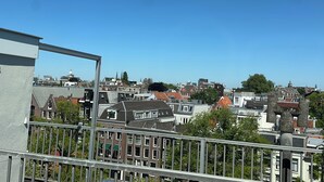 A cityscape with a variety of buildings, including residential and possibly commercial structures. - THE FRITZ HOTEL Amsterdam (Amsterdam)