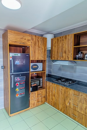 Superior Duplex, Balcony, City View | Private kitchen | Fridge, microwave, stovetop, cookware/dishes/utensils - G&G Residency (Douala)