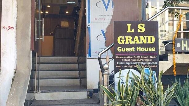 A staircase leading to a building with a sign for 'L S GRAND Guest House'. - L S Grand By GRB (Varanasi)