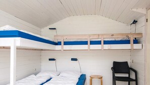 A bunk bed room with a wooden ladder, a small round stool, and a black chair. - 6 Person Holiday Park Home in Jelling (Jelling)