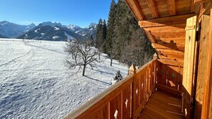 A wooden cabin with a balcony overlooking a snowy landscape and mountains. - Cosy Chalet With Balcony/terrace (Saanen)