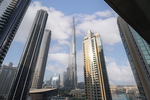 A high-rise urban area with modern skyscrapers, including a prominent tower with a spire.