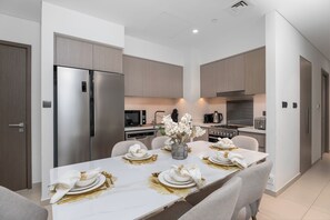 Deluxe Apartment, Balcony, City View | Dining room - Nasma Holiday Homes - Act One Act Two Tower 2 (Dubai)