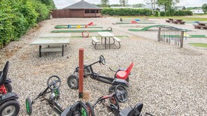 A playground with various play equipment, picnic tables, and a covered seating area. - 4 Person Holiday Park Home in Jelling (Jelling)