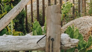 A wooden sign with the word "PLAGE" on it, set against a backdrop of greenery and a rustic fence. - Case di Pigna magnificent recent VILLA 2 to 6 pers private swimming pool near Algajola (pigna)