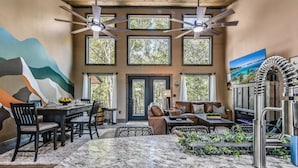 A dining area with a marble table, chairs, and a ceiling fan.