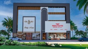 A modern building with a large sign for RedTape Online Outlet, featuring sections for men, women, boys, and girls. - Pinky Hotel (Dausa)