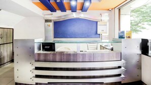 A reception desk with a glass top, a blue headboard, and a sign reading "Thank You." - Pinky Hotel (Dausa)