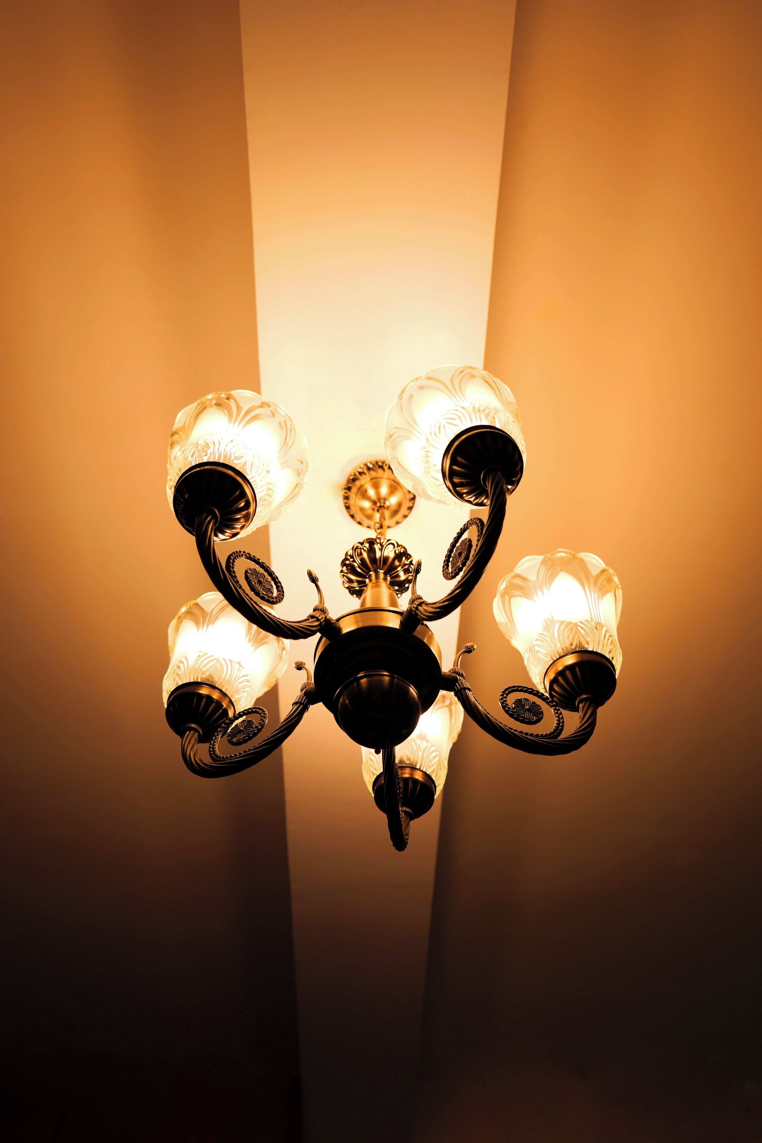 A chandelier with multiple glass shades and ornate metalwork.