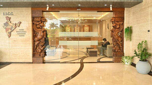 The entrance of the Indore International Convention Center with a map of India, wooden carvings, and a seating area inside. - INDORE INTERNATIONAL CONVENTION CENTER (Sanwer)