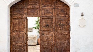 A large wooden door with a metal handle and a small plaque. - Casa a Corte (Nardò)