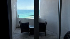 A balcony with two wicker chairs and a view of the ocean. - Ocean view with balcony private  Efficieny  atThe OceanManor (Fort Lauderdale)