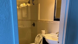 A bathroom with a toilet, sink, and shower. - Ocean view with balcony private  Efficieny  atThe OceanManor (Fort Lauderdale)