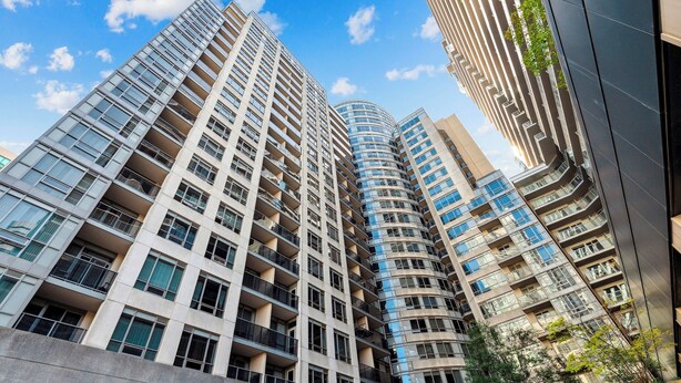 A high-rise building with multiple balconies and large windows, likely part of a residential or hotel complex. - Charming 1-BR Condo in DR Toronto (Toronto)