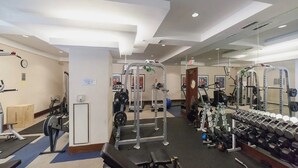 A gym with various exercise equipment, including weight machines, dumbbells, and a bench. - Centrally Located 2-BR Condo in DT Toronto (Toronto)