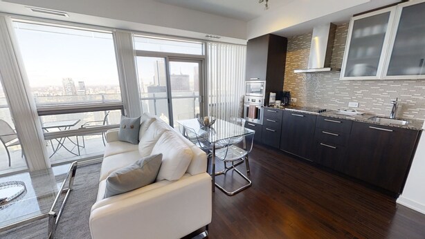 A modern apartment with a living room, dining area, and kitchen. - Fully-Equipped 3-BR Condo in DT Toronto (Toronto)