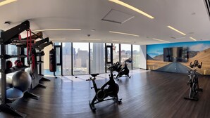 A modern gym with exercise equipment, large windows, and a city view. - Lovely 1-BR in DT Toronto (Toronto)