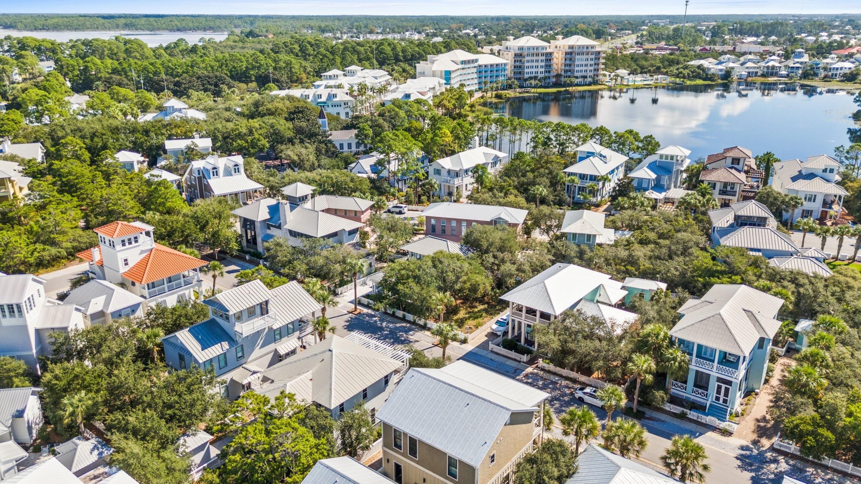 An aerial view of a residential area with houses, a lake, and a marina.