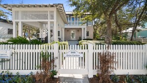 A two-story house with a white picket fence, a porch, and a mailbox. - Carillon Beach - Grits Carlton by PHG (Panama City Beach)