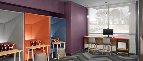 A modern office space with a large desk, two chairs, a computer, and a window with a view of trees.