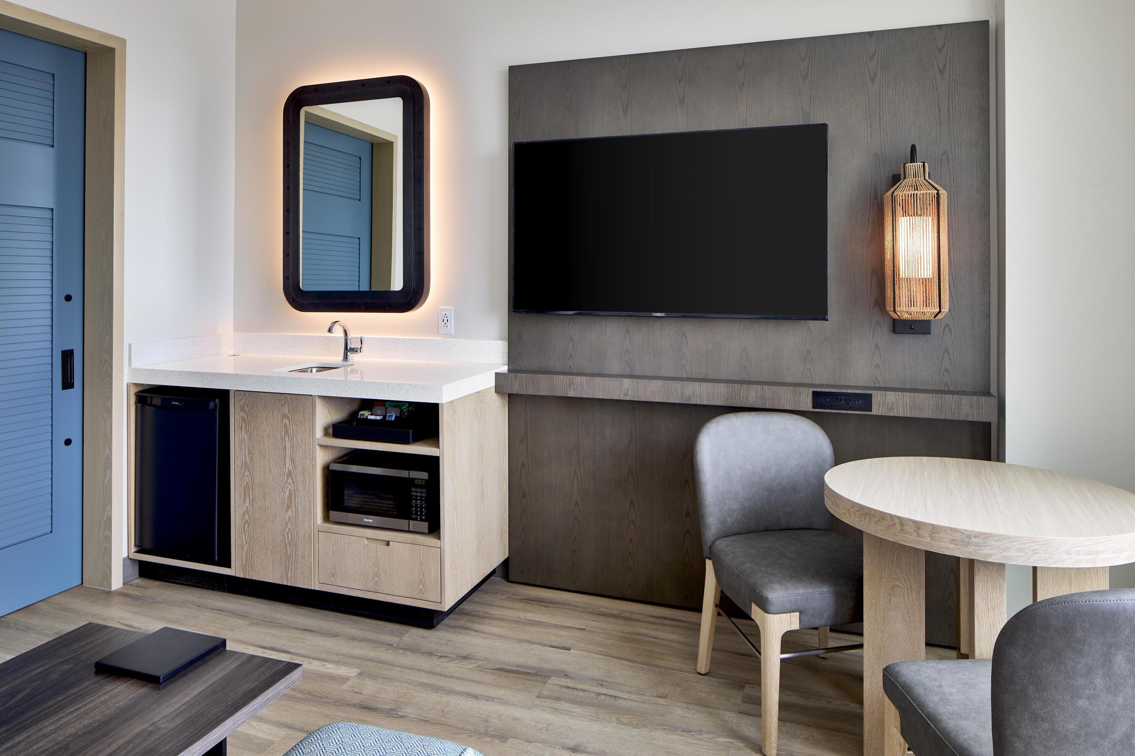 A modern bathroom with a sink, mirror, and toilet.