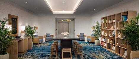 A modern room with a central table, seating, a bookshelf, and potted plants.