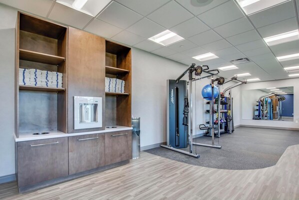 A gym with exercise equipment, a mirror, and storage cabinets. - Hampton Inn & Suites By Hilton Louisville East Oxmoor (Louisville)