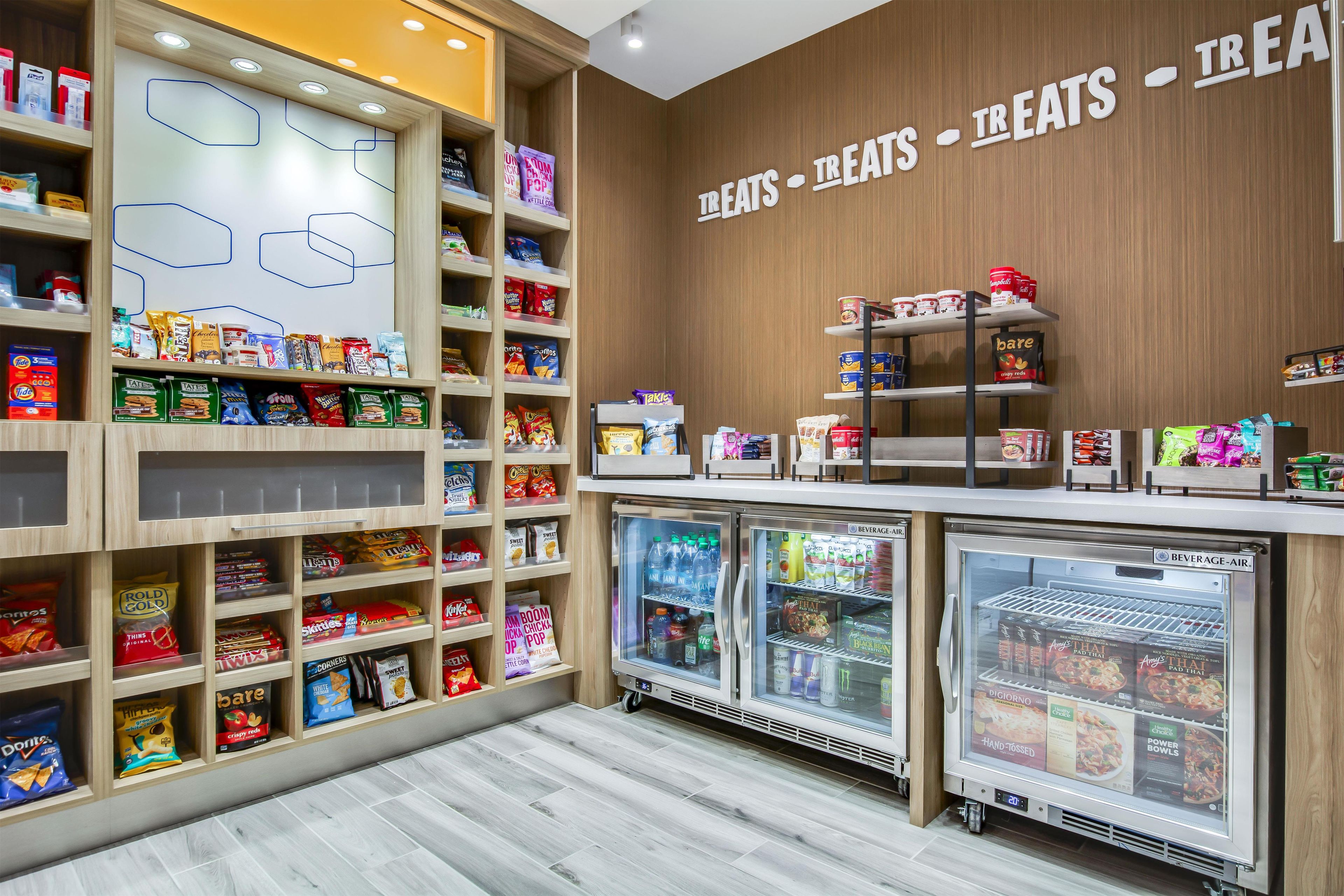 A snack and beverage kiosk with various packaged snacks and drinks.