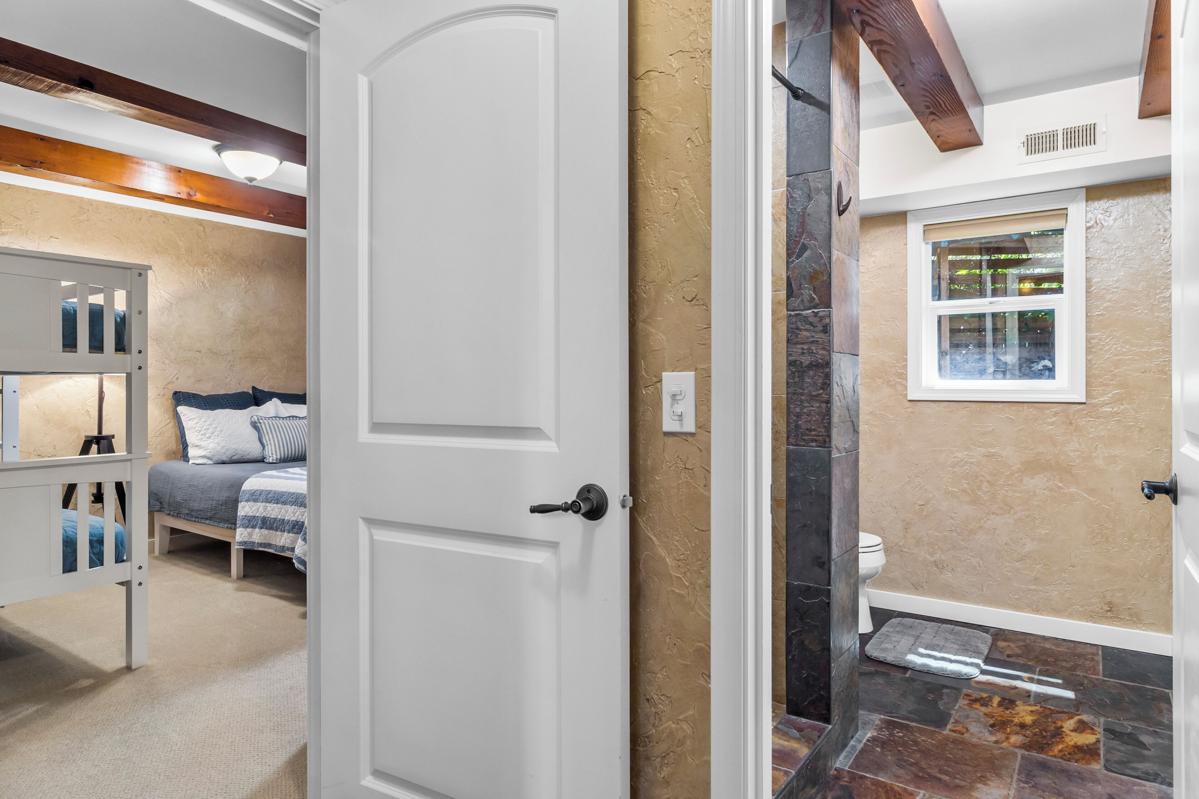 A bedroom with a bed, a nightstand, and a wardrobe.